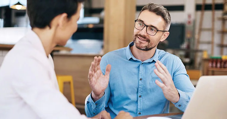 A man and woman having a business meeting in an office