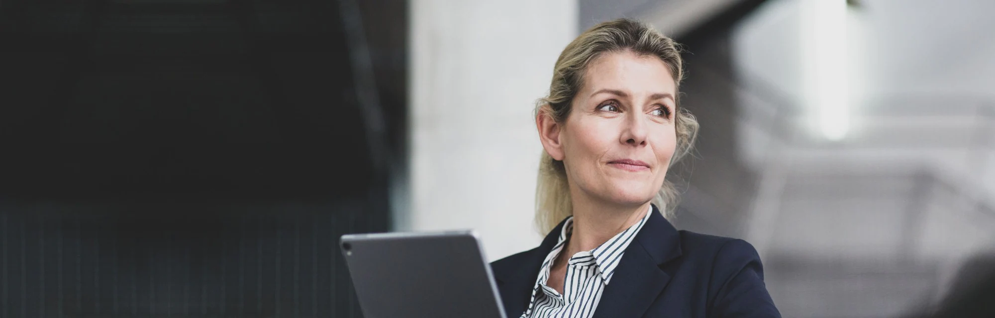 Woman using her tablet to sign on to  New Norwhich Online SmartBanking for Business